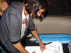 kiowa gordon signing wizard jeans for charity.jpg
